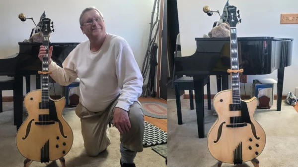 Charles Perry proudly with his Natural Blonde Conti Entrada Archtop featuring the Midnight Package