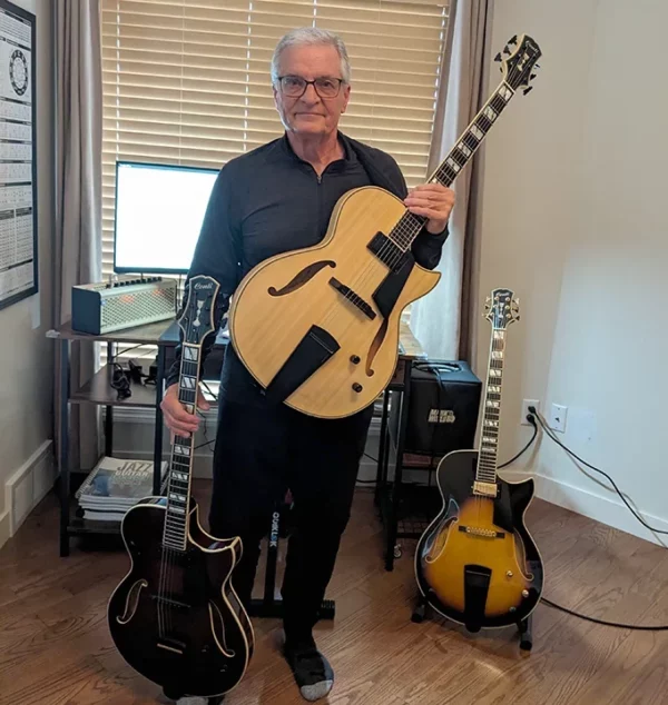 Lonnie Smith poses with his three Conti Archtop Jazz Guitars