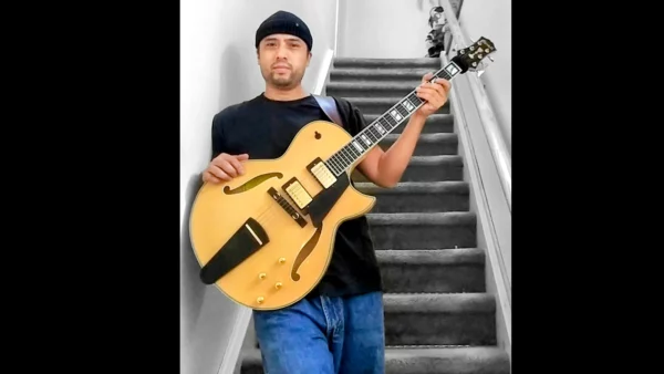 Jaime Bruno of Toronto Canada stands proudly with his beautiful natural blonde Conti Entrada archtop jazz guitar, double pickup version