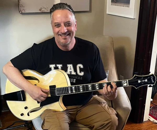 Joel holding his beautiful new natural finish Conti Entrada archtop jazz guitar featuring the timeless Midnight Package upgrade.